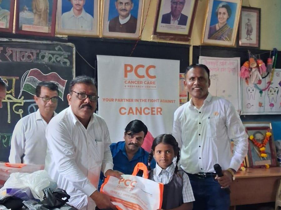 Oncourage team distributing books and stationery to school children